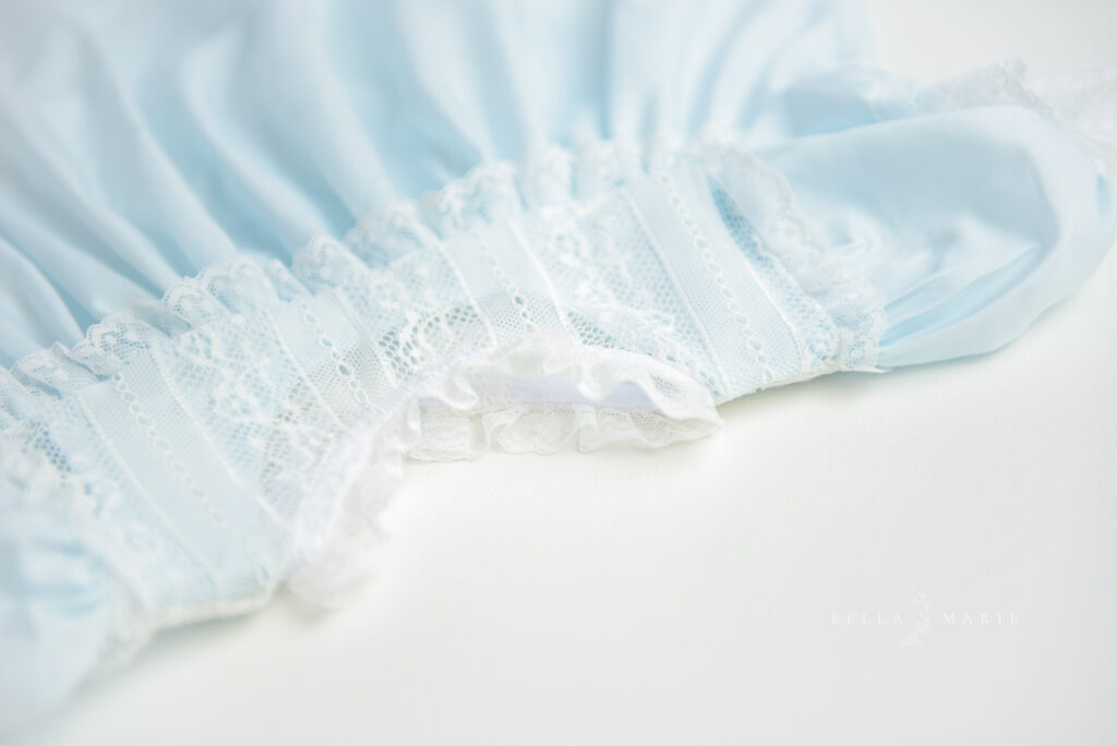 flat lay of blue and white lace dress for toddler girl.